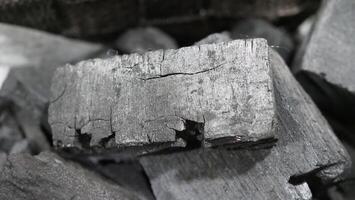 Natural wood charcoal traditional charcoal or hard wood charcoal on wooden table top view. photo