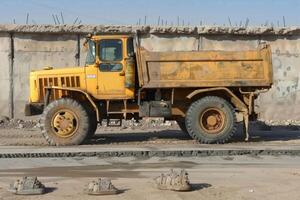Side View of Saudi Arabian Style Grader Truck with Concrete Shoes on the Ground photo