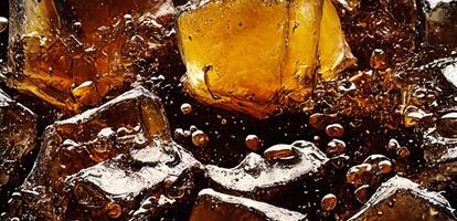 Cola with Ice. Close up of the ice cubes in cola water. Texture of carbonate drink with bubbles in glass. Cola soda and ice splashing fizzing or floating up to top of surface. Cold drink background. photo
