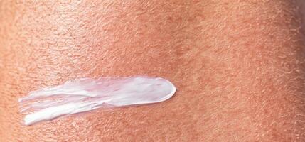 Close up of Sunscreen Protection or Sun Cream on human skin. photo