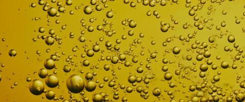 Golden Hyaluron Oil bubbles collagen serum or yellow oil bubbles drop texture background photo