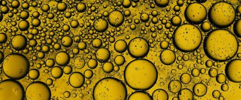 Golden Hyaluron Oil bubbles collagen serum or yellow oil bubbles drop texture background photo