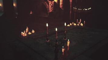 A table with a group of temple candles illuminated video