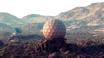 A satellite dish mounted on a mountain peak for observatory surveillance video