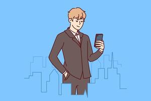 Successful businessman stands in downtown with miniature buildings and holds mobile phone vector