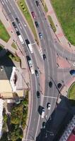 vertical accelerated aerial video above road junction with heavy traffic