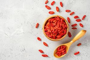 AI generated Dried goji berries in a wooden bowl photo