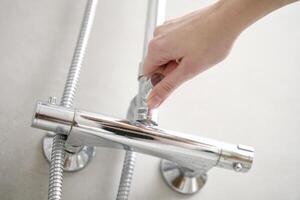 Woman use shower in bathroom photo