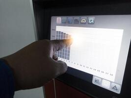 The engineer an engineer is pointing at a display data graphics on display Technology of  hatchery machine. photo