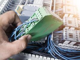 Check and repair electrical component the automatic turning relay on the panel board control machinery. photo