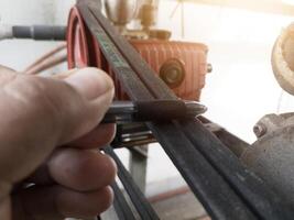 Checking the tenssion of the belt pulley using hand estimates. photo