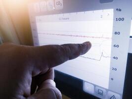 The engineer an engineer is pointing at a display data graphics on display Technology of  hatchery machine. photo