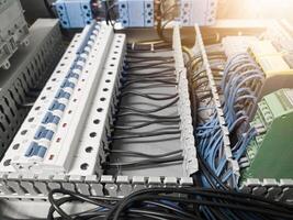 Voltage switchboard with circuit breakers on the panel board. Wire connection board. Electrical background photo