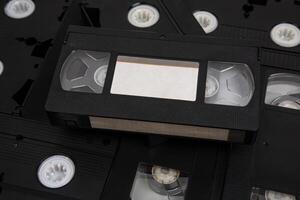 Videotape with blank tags. Pile of VHS video cassettes. Vintage media. Isolate on a white back photo