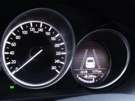 Speedometer and display of active collision prevention assist on car dashboard photo