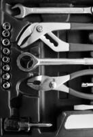 Plastic toolbox with arranged mechanics tools and equipment black and white stock photo