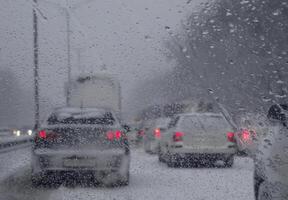 Vehicles in traffic trouble on the road in extreme winter conditions photo