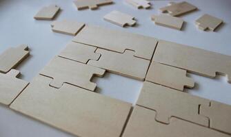 Disassembled rectangular panel from plywood puzzles and a set of additional elements photo