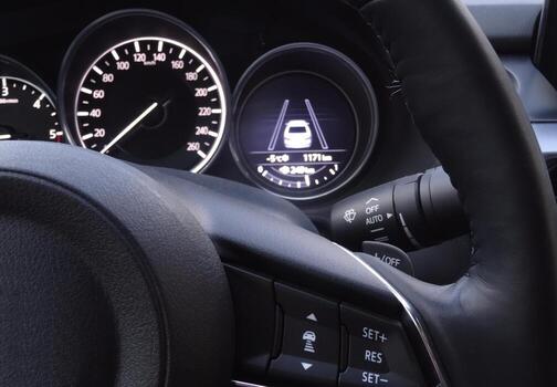 Controls on steering wheel and display of collision avoidance system on car dashboard photo