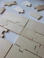 One missing piece in a rectangle assembled from wooden puzzles photo