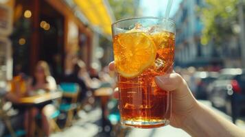 AI generated Outdoor cafe with hands holding a glass of refreshing iced tea photo