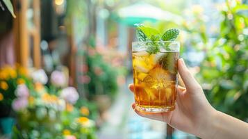 AI generated Outdoor cafe with hands holding a glass of refreshing iced tea photo