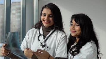 Indian medical students interns analyze the X-ray in a modern clinic. Indian doctor. Higher Education for woman video