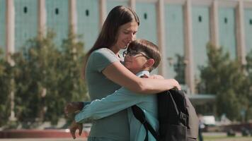 Online education, Back to school, Happy schoolboy, Learn lessons. Woman hugs schoolboy and sends him to school video