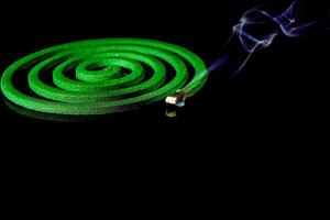 close-up of mosquito repellent burning on black background. photo