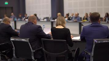 A group of businessmen are discussing business and finance at a round table at a conference. video