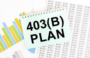 403b plan text on a note with financial charts and graphs in the background photo