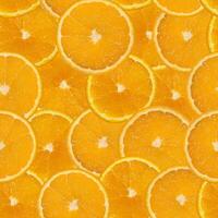 seamless pattern of bright juicy orange, cut into circles photo