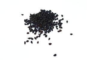 Black cumin seeds pile isolated on white background photo