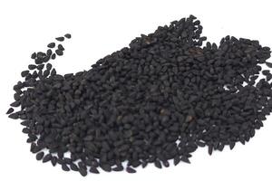 Black cumin seeds pile isolated on white background photo