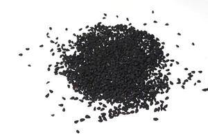 Black cumin seeds pile isolated on white background photo