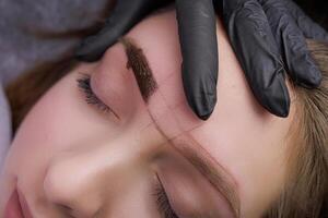 Macro photo of the eyebrow after the pigment has been applied to the skin. PMU Procedure, Permanent Eyebrow Makeup.