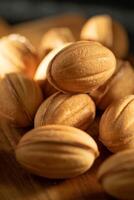 close up of a pile of almonds on a rustic wooden board photo