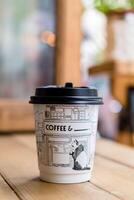 Coffee cup on wooden table in coffee shop, stock photo