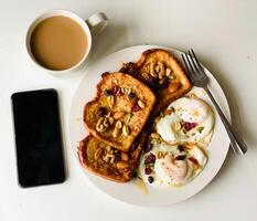 Breakfast with fried eggs, coffee and toast on white background. photo