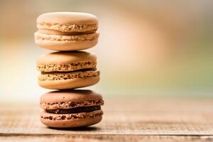 Stack of colorful macaroons on wooden table, shallow depth of field photo