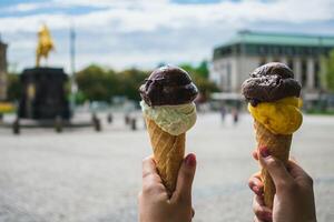 Ice cream cone in hand on the background of the monument to the Great Patriotic War photo