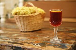 Beverage with Lemon in Glass on Wooden Table photo