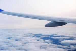 Serene Sky and Airplane Wing at High Altitude photo