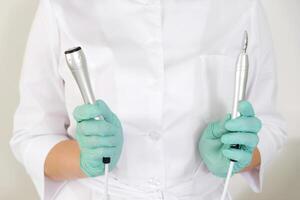 Cosmetologist Holding Electroporation and RF Lifting Devices photo