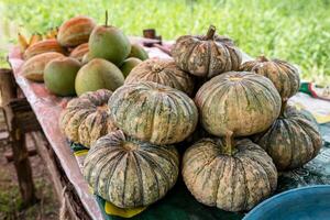 A close-up view of a cluster of pumpkins and other fruits. photo