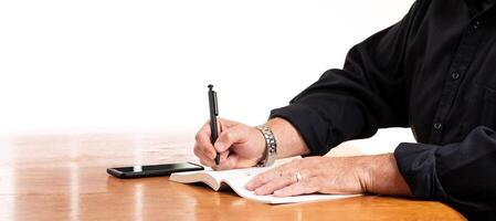 Businessman Handwriting Signature in a Book with Black Pen on White Background photo