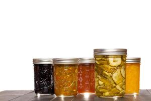 Preserved Pickle Slices Relish Fruit Jams and Jelly in Glass Canning Jars photo