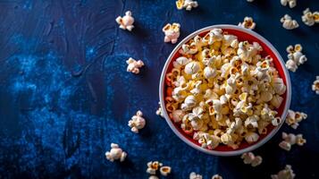 AI Generated Bowl of fresh popcorn on dark blue background photo