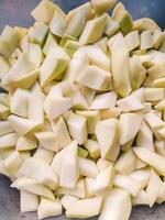 Chayote sliced. Chayote fruit, Brazilian cuisine. Chopped fruit in container photo