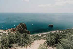 Sea lagoon. Panoramic view on calm azure sea and volcanic rocky photo